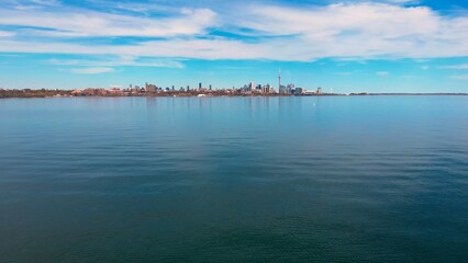 Calm lake, clear day, urban landscape backdrop, health focus. Health reflected serene, clear skies,...