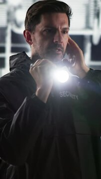 Security Guard At Night With Flashlight