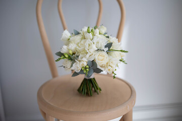 Beautiful bouquet of white flowers on a chair.