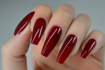 red nails with a long red nail, in the style of naturalistic proportions, glossy finish, maroon, and thick texture. beauty and fashion concept.
