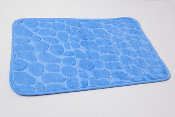 New bath mat isolated on white. Bathroom rug