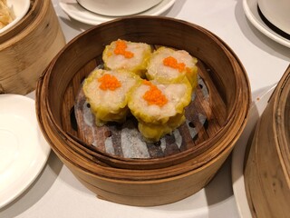Dim Sum Steamed Pork Dumplings (Shu Mai) in bamboo steamer. Yumcha, Cantonese food style. Chinese cuisine.