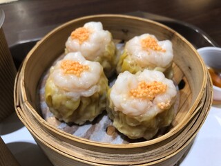 Dim Sum Steamed Pork Dumplings (Shu Mai) in bamboo steamer. Yumcha, Cantonese food style. Chinese cuisine.