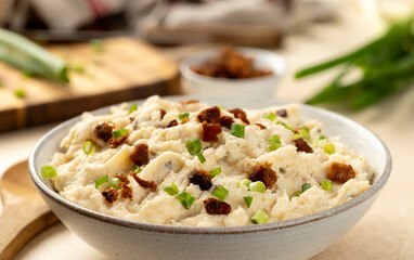 Bowl of mashed potatoes with bacon and green onion