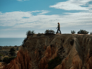 Woman posing in a cliff in portugal
