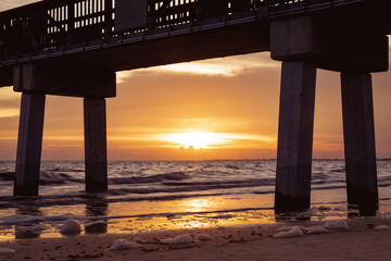 Sunset behind the pier of Fort Myers Beach, Florida USA