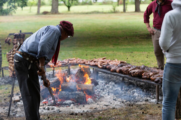 guacho roasting angus beef in the pampas countryside