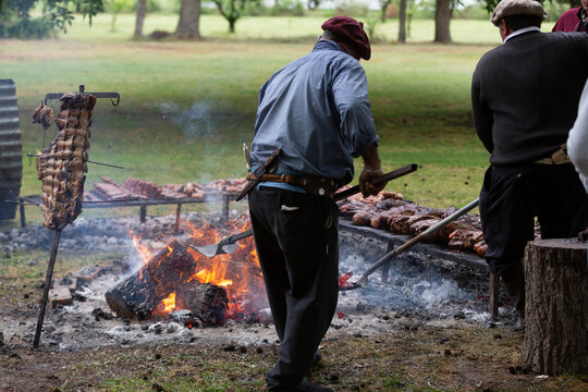 guacho roasting angus beef in the pampas countryside