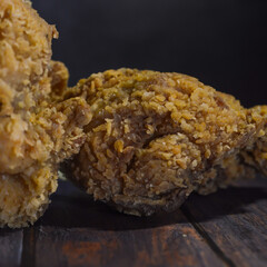 Super crunchy fried chicken on a black background. selected focus.