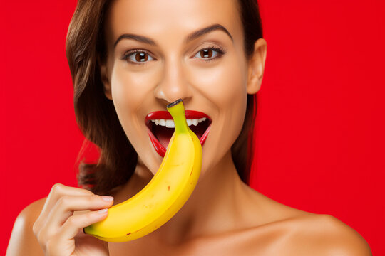 Sexy Woman With Red Lips Taking A Bite From Yellow Banana