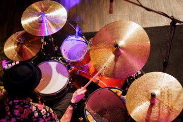 A musician plays a drum kit, top view of drums set.