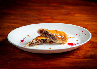 Apple strudel with cinnamon. On a wooden table.