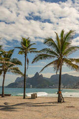 Rio de janeiro, Brazil. Leblon Beach and Dois Irm&atilde;os hill seen from Millor Square in Arpoador with the palm trees on a sunny day.