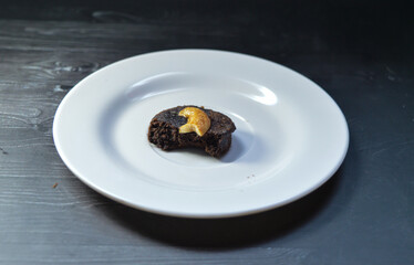 Homemade chocolate cake with cashew nut topping.