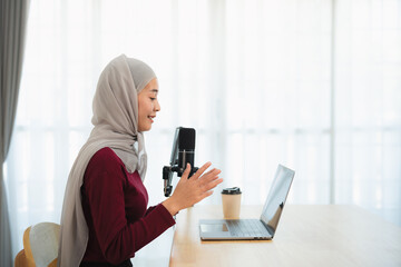 Muslim Islam freelance entrepreneur woman wearing hijab and talking while conference meeting,...