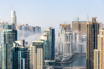 Majestic mornings: Dubai Marina's skyline embraced by ethereal fog