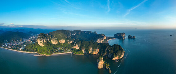 View from above, aerial shot, panoramic view of the Ao Nang coast at sunset with the Ao Nang Tower, Tonsai beach and Railay Beach in the distance, Krabi, Thailand.