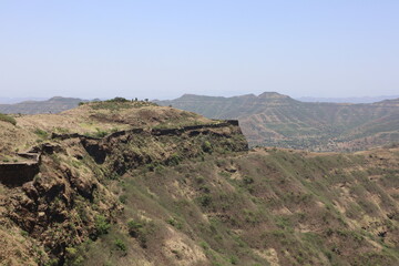Fototapeta na wymiar Dried Hills surrounding Sinhagad Fort Exploring the Surroundings of Sinhagad Fort in Pune