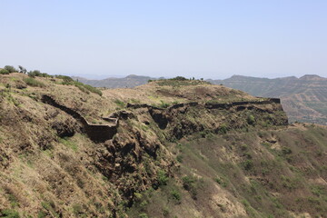 Fototapeta na wymiar Dried Hills surrounding Sinhagad Fort Exploring the Surroundings of Sinhagad Fort in Pune
