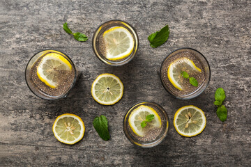 Healthy breakfast or morning with chia seeds lemon and mint on table background, vegetarian food, diet and health concept. Chia pudding with lemon and mint