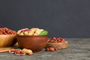 Fresh healthy peanuts in bowl on colored table background. Top view Healthy eating bertholletia concept. Super foods