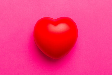 red heart shape on colored background. minimal concept top view with copy space