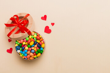 Valentine day composition: sweet candy, with gift boxes with bow and red felt hearts, photo template, background. Top View with copy space