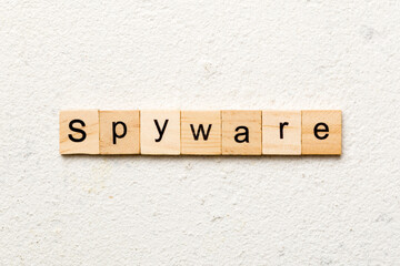spyware word written on wood block. spyware text on cement table for your desing, concept