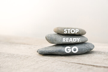 Stop, Ready, Go written on stones. Copy space