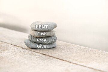 Lent, Fast, Pray and Give written on stones. Lent Season, Holy Week and Good Friday concept