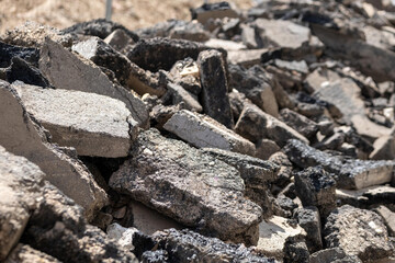 torn up road with chunks of tar