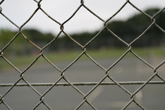 Iron net around tennis court protection.Image of the fence and sky