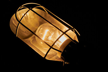 an old lamp shines on a dark background, Lamp night light in a dark background. Vintage effect...