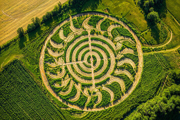 Sun star design alien crop circle in green field, artist impression, conspiracy theory, UFO