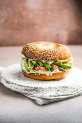 Hearty Breakfast Sandwich on a Bagel with avocado, salmon, egg