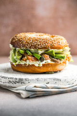 Hearty Breakfast Sandwich on a Bagel with avocado, salmon, egg
