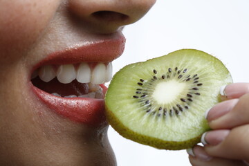 woman eating kiwi close up