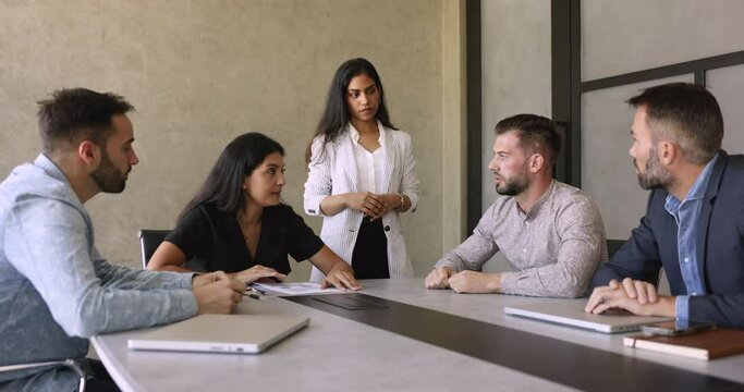 Businesspeople sit at desk, lead conversation, discuss agreement details, express acceptance shake hands, concluding commercial deal in office during meeting with client. Negotiations, make business