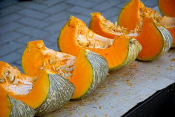 fresh pumpkin cut open heap of pumpkins in vegetable market for sale - 713379547