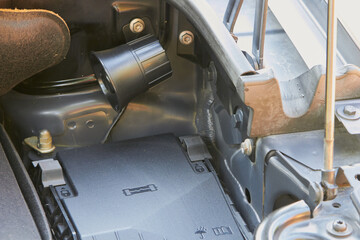 car horn under the hood, open hood of a car with sound signals