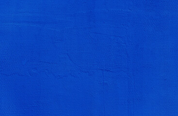 Blue wall background. Abstract wall surface with blue plaster texture for design. Close up.