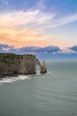 Etretat in Normandy, the famous cliffs and needle on the pebble beach
