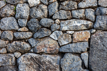 Background of stones. Masonry from stones of different sizes