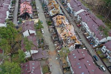 Hostomel, Kyev region Ukraine - 09.04.2022: Top view of the destroyed and burnt houses. Houses were destroyed by rockets or mines from Russian soldiers. Cities of Ukraine after the Russian occupation. - 713387765