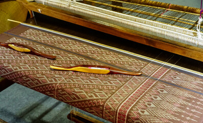 Shuttle on the antique wooden loom and thread for silk weaving, Details handloom silk yarn for...