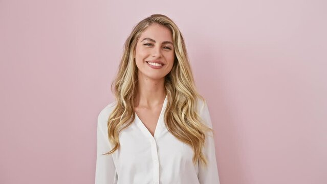 Zany young blonde woman wearing shirt stands over pink background, tongue out in a funny expression! pure fun and happy emotions flowing.