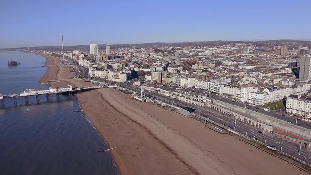 Brighton City seafront with it's Victorian Palace Pier and Victorian buildings along Marine Drive aerial video.