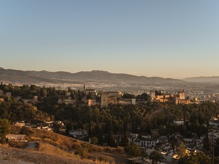 Fototapeta na wymiar Panoramic view of the castle Alhambra in Granada, Andalusia, Spain, during sunset, from the Mirador de la Cruz de Rauda