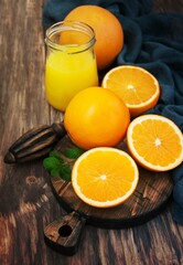 Jar of juice and fresh oranges