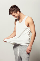Smile, morning and pajamas with a young man in studio on a white background to wake up in a good...
